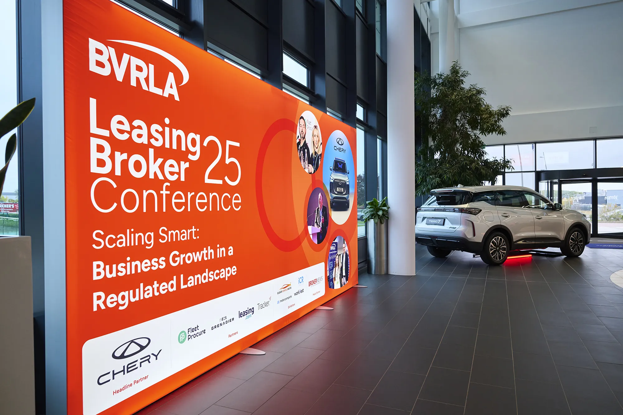 Large graphic by door at Leasing Broker Conference venue, car in background
