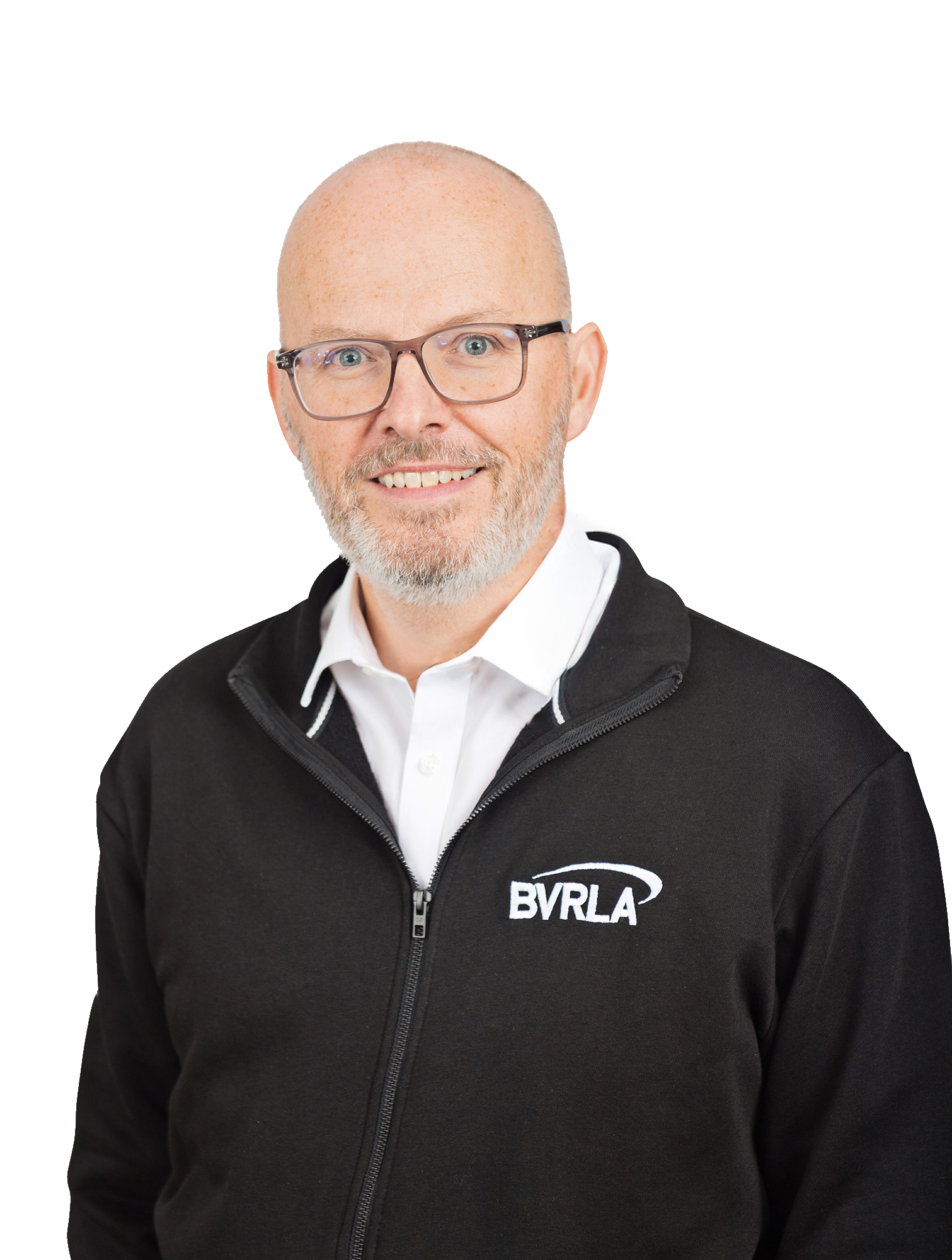 BVRLA Chief Executive Toby Poston, who is smiling and wearing a white shirt and a sweatshirt with the BVRLA logo on it