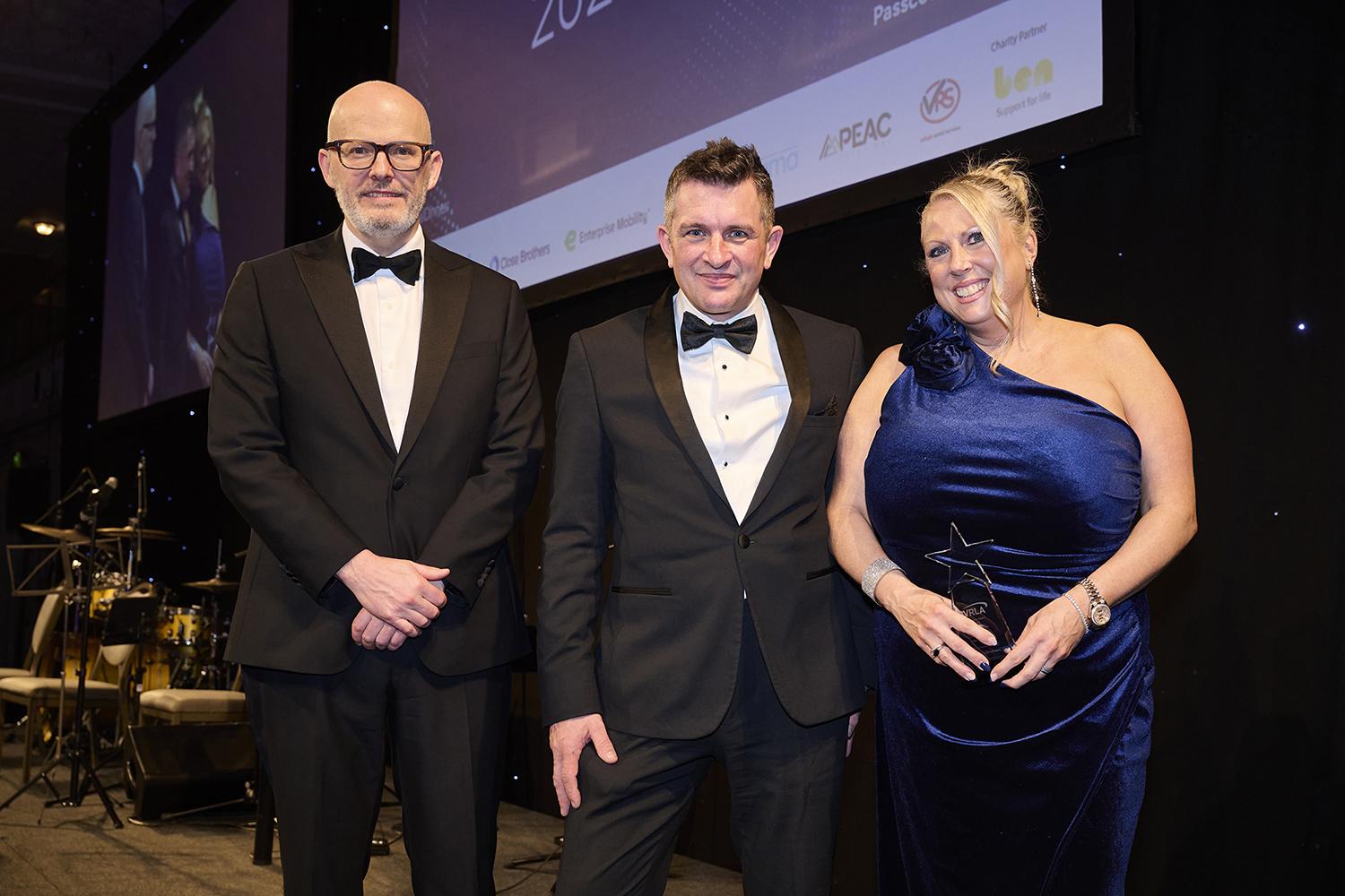 Claire Coomber from Alphabet (GB) receiving award from Toby Poston and James Comrie of Close Brothers