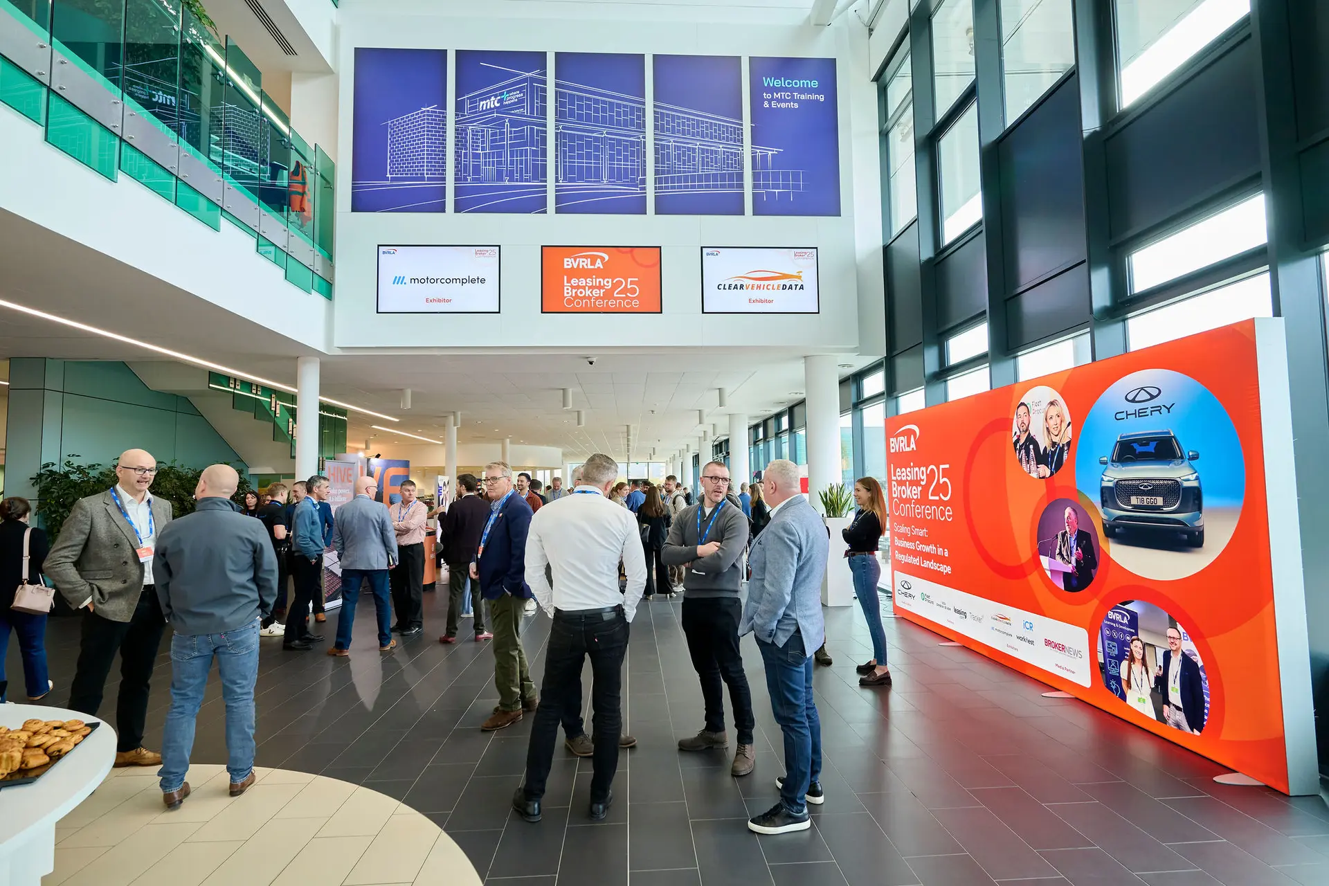 For foyer of the venue with people standing in groups chatting at the 2025 BVRLA Leasing Broker Conference