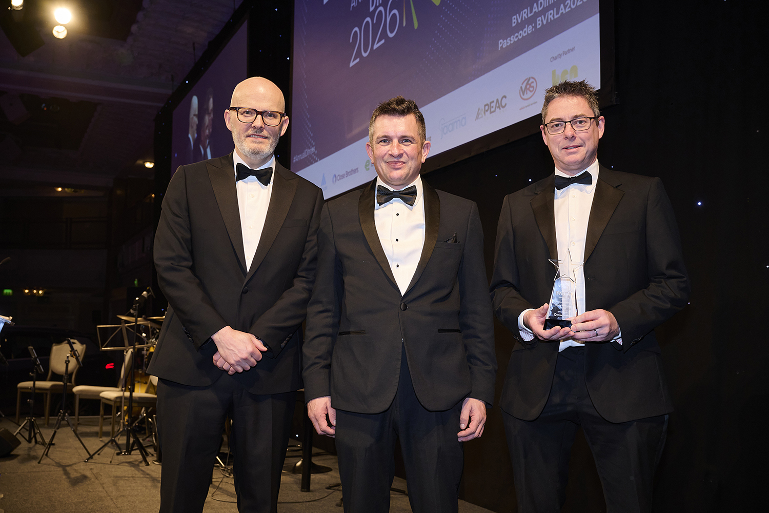 Stuart Chamberlain of Arval UK receiving award from Toby Poston and James Comrie of Close Brothers