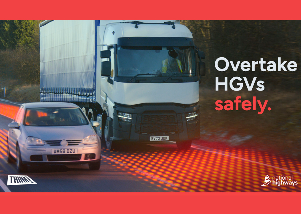 A car overtaking a lorry with danger zones highlighted in red, part of National Highway's Overtake HGVs safely campaig