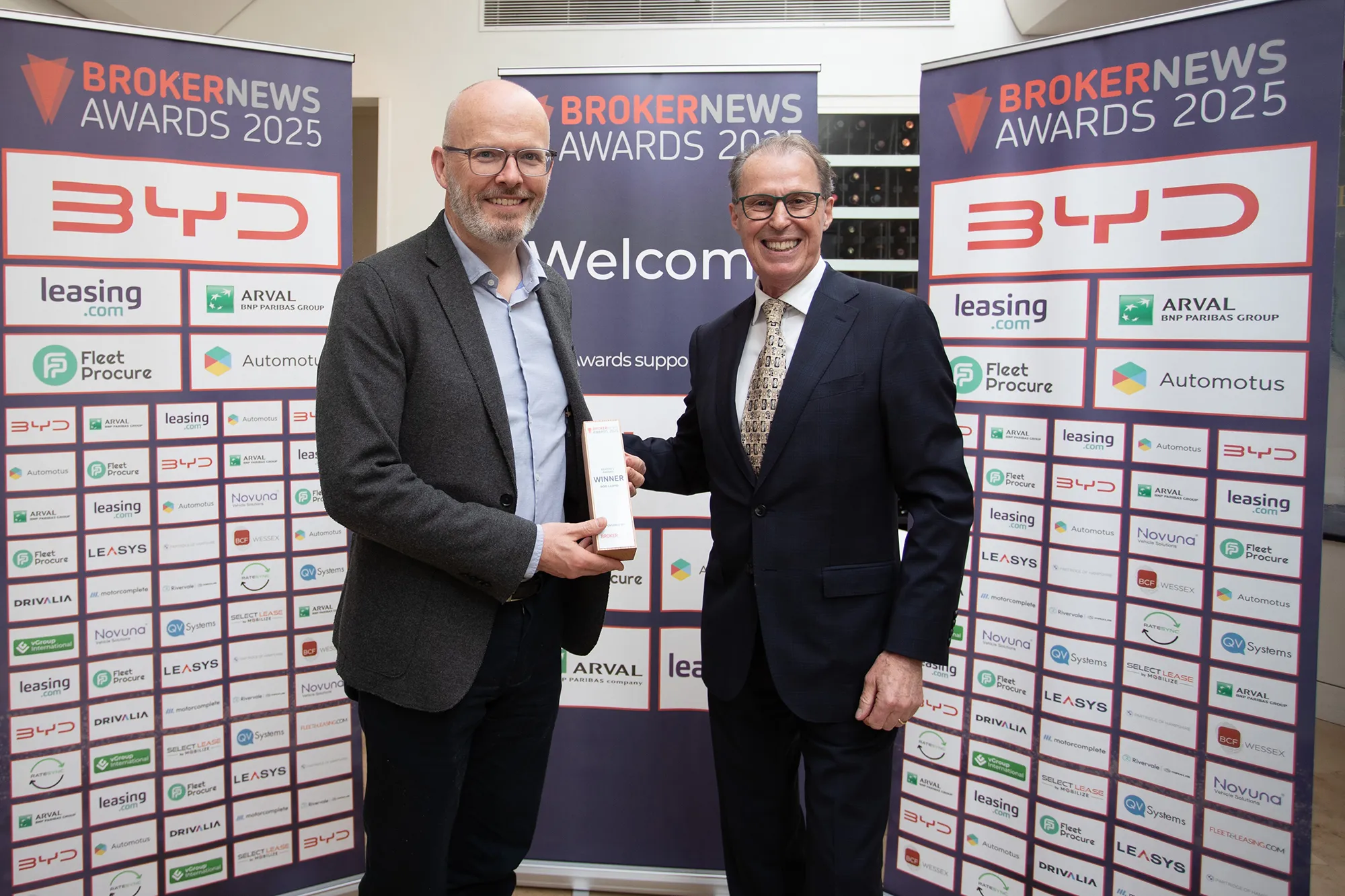 Toby Poston accepts award on Rod Lloyd's behalf from Ralph Morton of Broker News